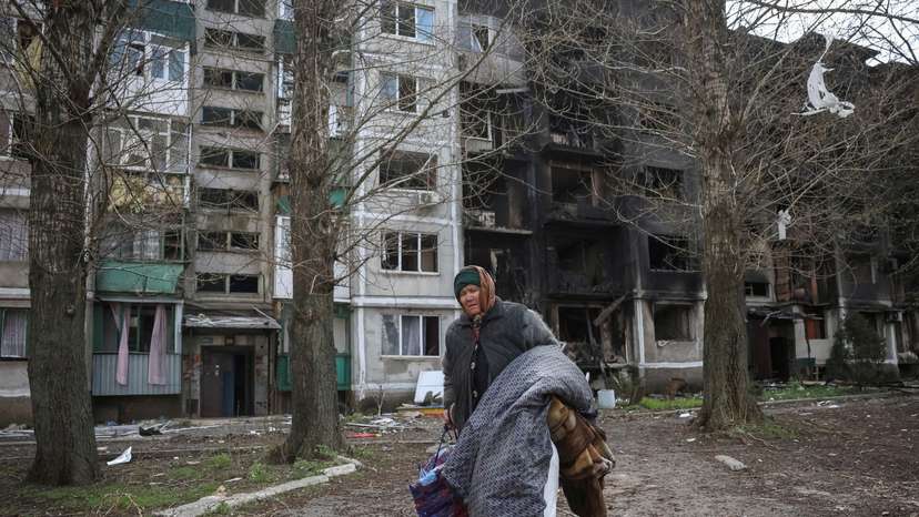 FILE PHOTO: A woman carries her belongings during evacuation in the frontline town of Pokrovsk