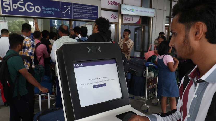 A passenger reads a message after he tried to use a self-check-in kiosk at a departure area at Sardar Vallabhbhai Patel International Airport following a global IT outage, in Ahmedabad