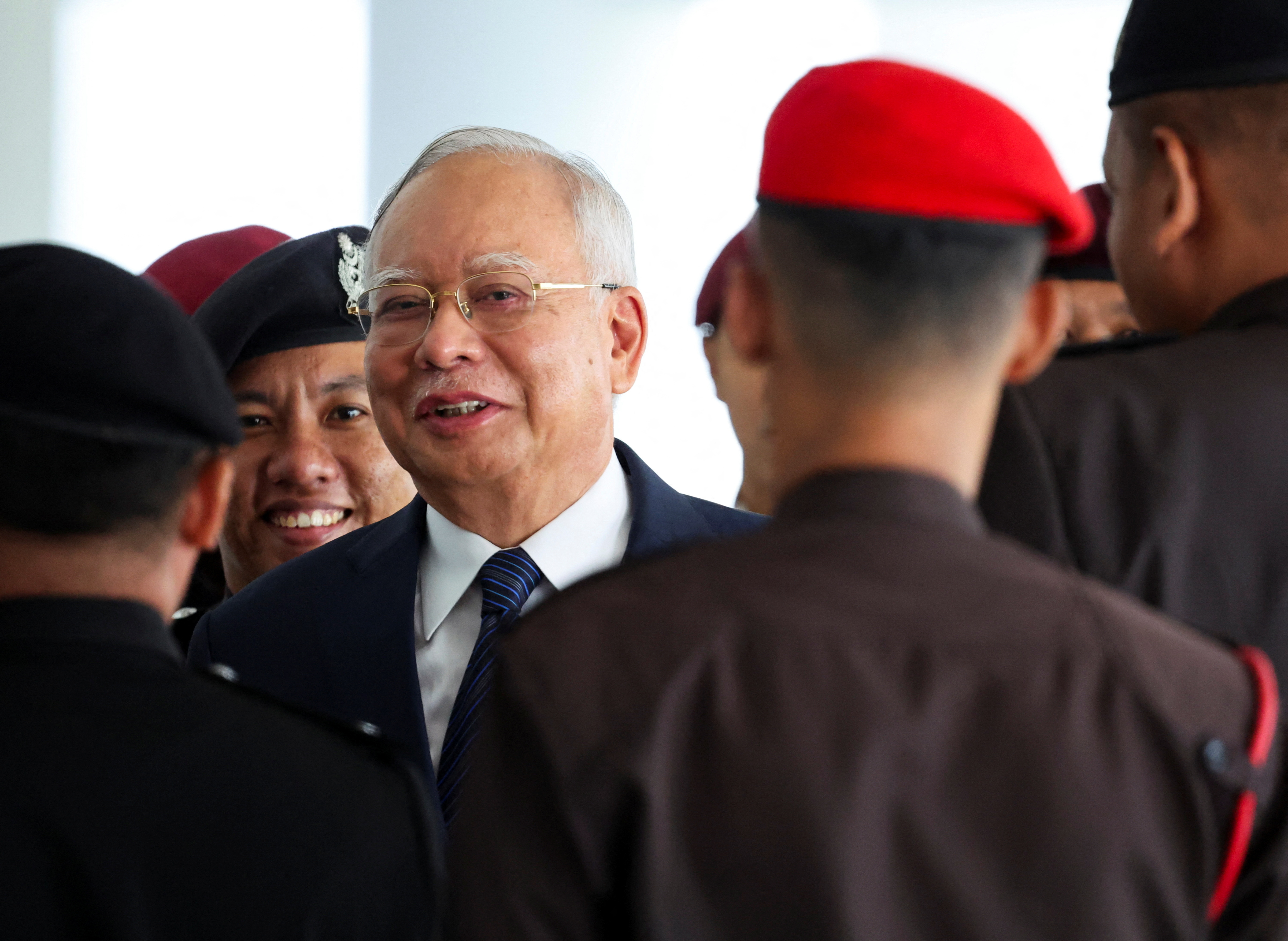 Prison officers escort former Malaysian PM Razak, in Kuala Lumpur