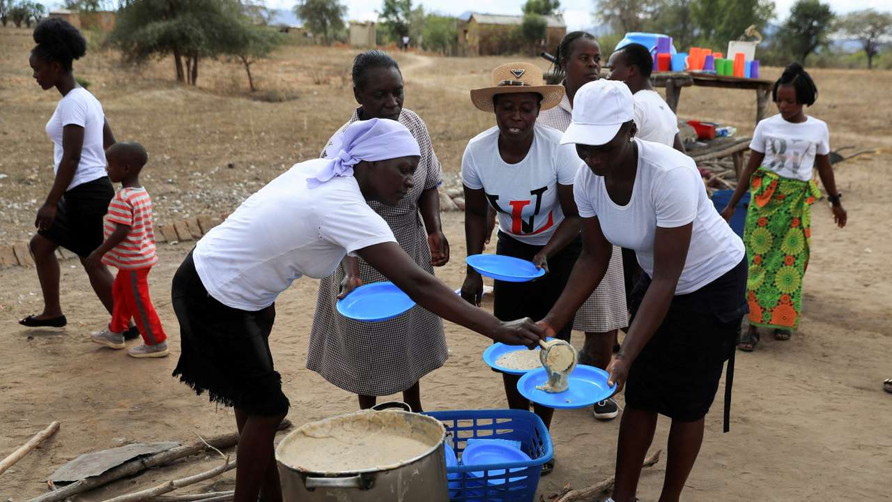 FILE PHOTO: A woman serves traditional porridge at a rural home, in Kotwa in Mudzi district