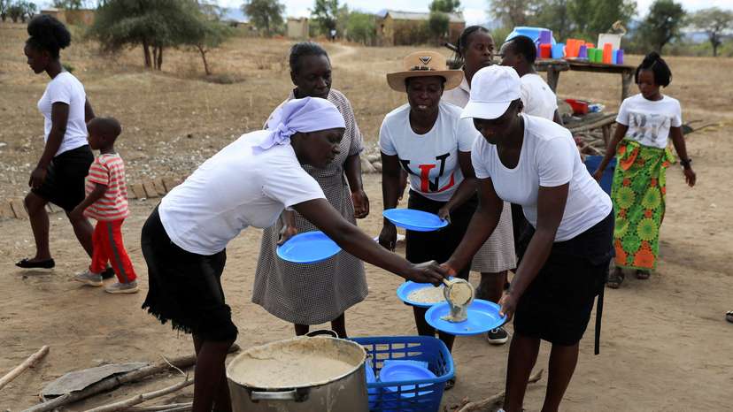 FILE PHOTO: A woman serves traditional porridge at a rural home, in Kotwa in Mudzi district