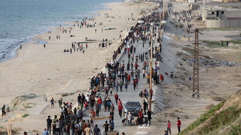 Palestinians gather in the hope of obtaining aid delivered into Gaza through a U.S.-built pier, as seen from central Gaza Strip