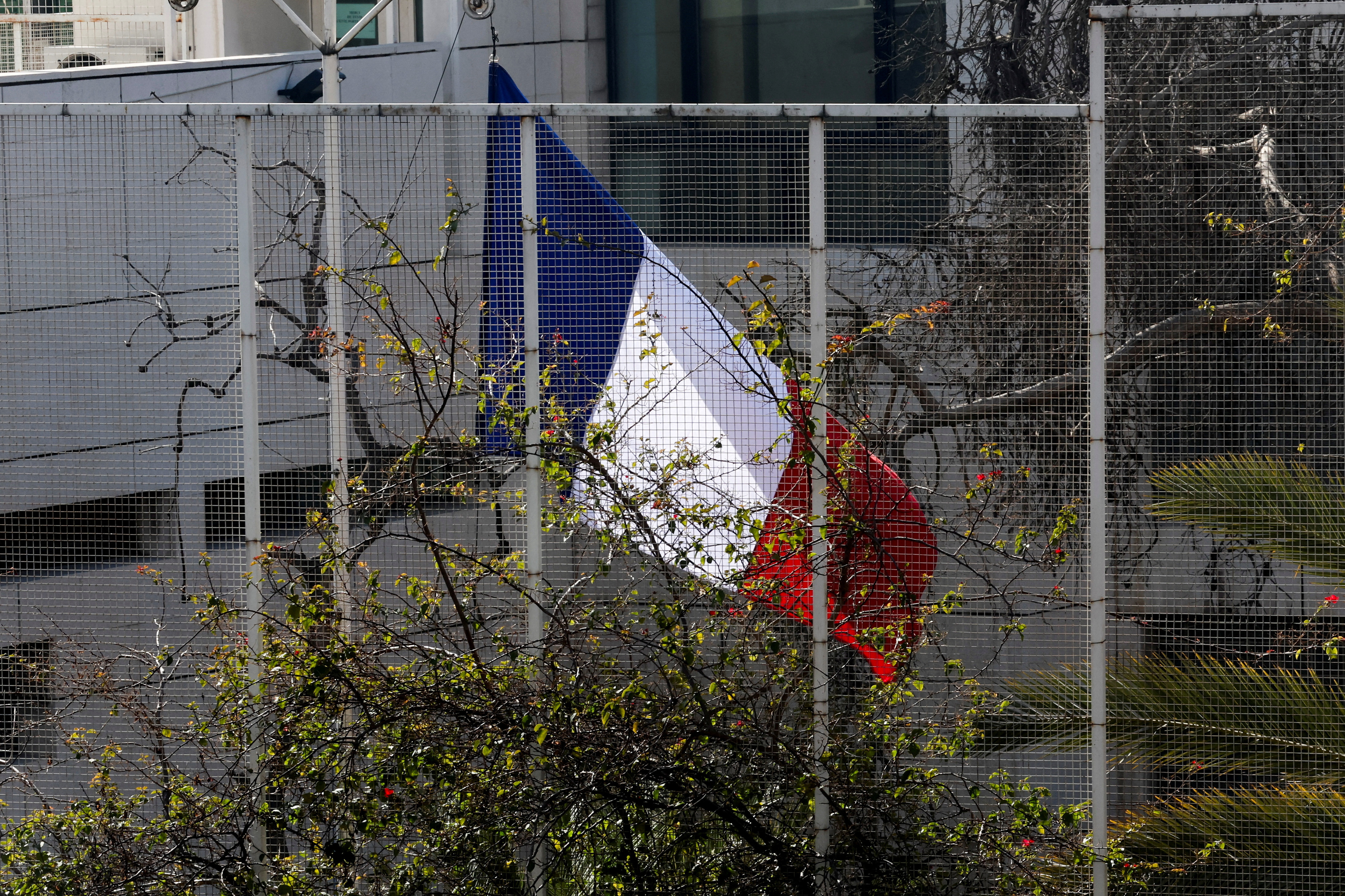 The French national flag is raised at the French embassy in Damascus