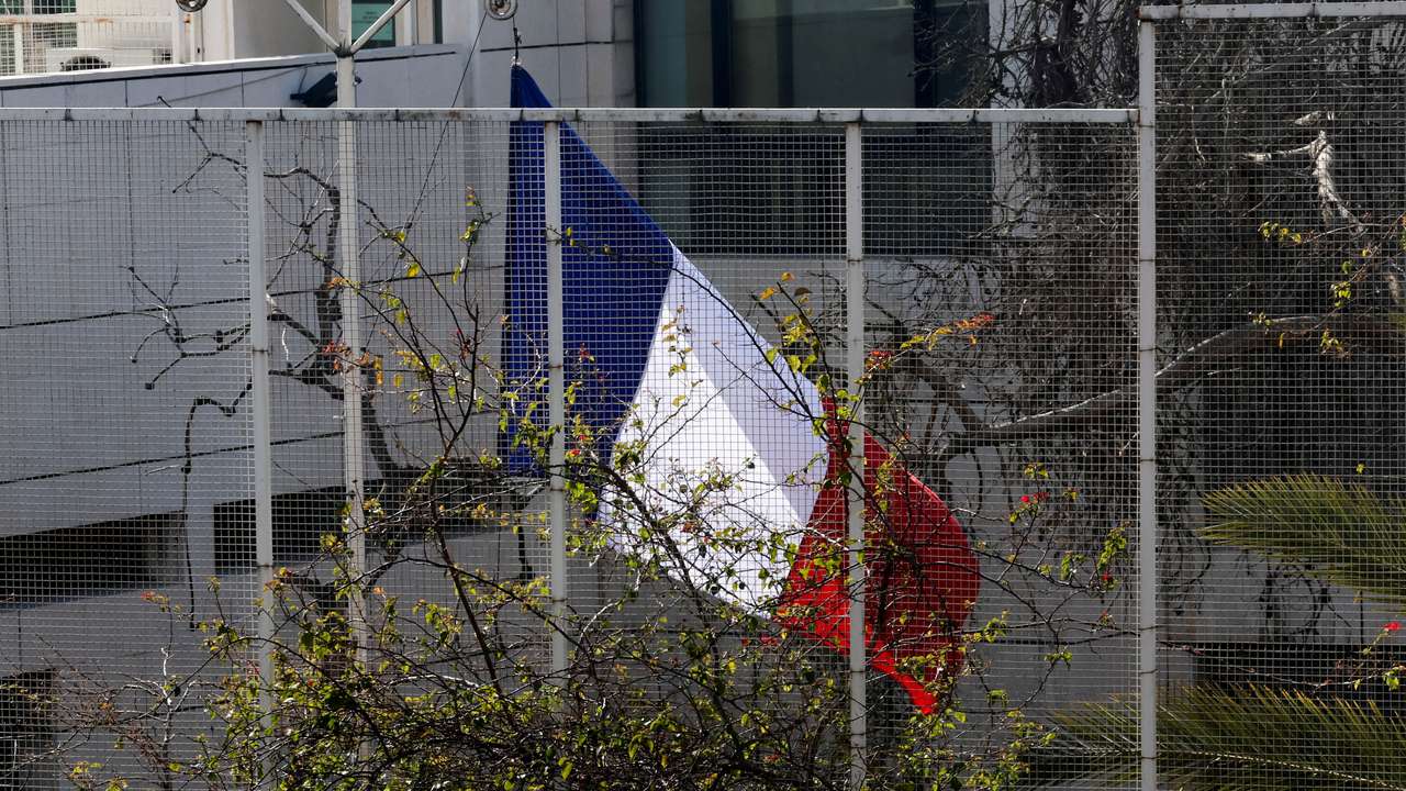 The French national flag is raised at the French embassy in Damascus