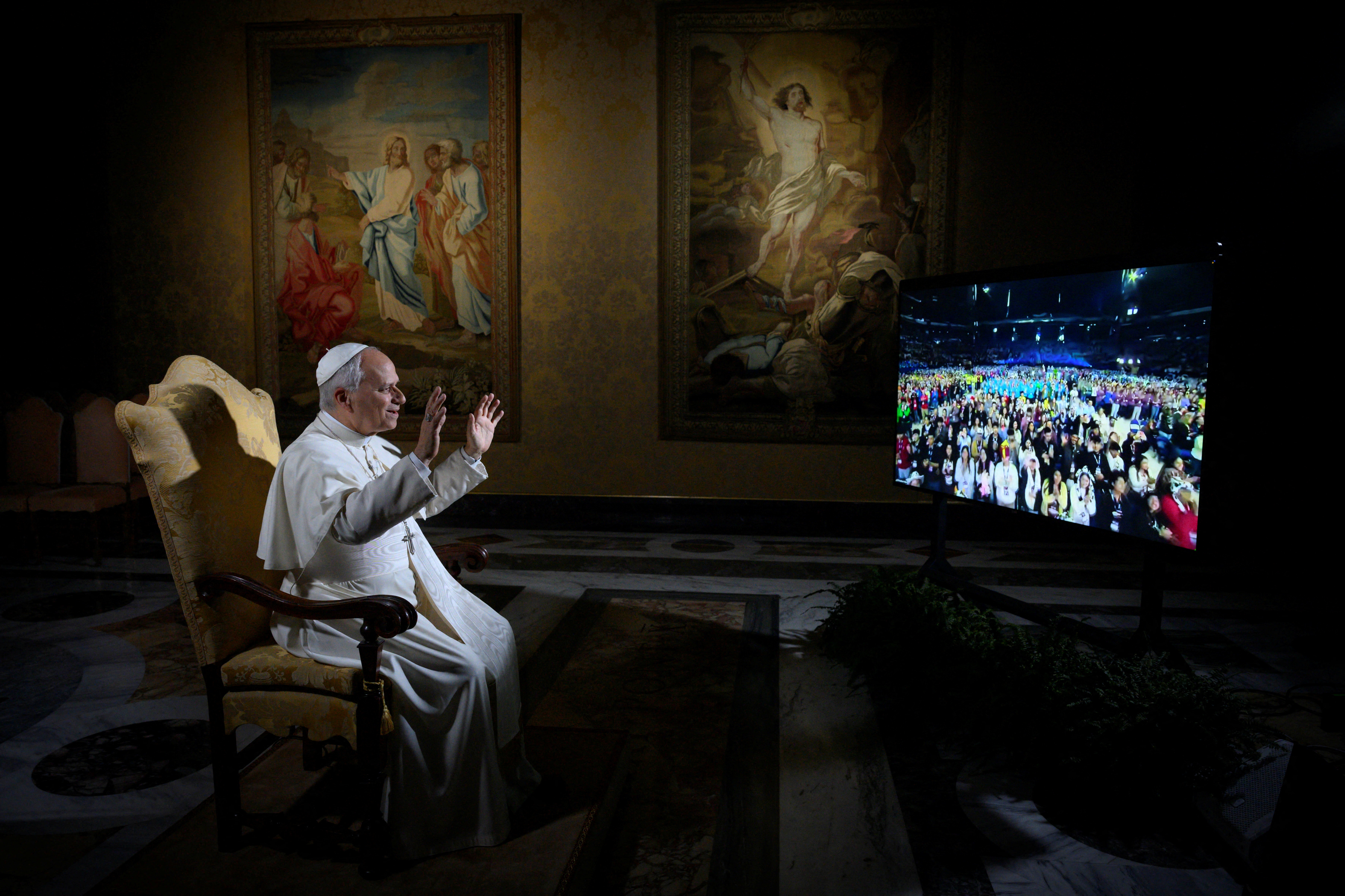 Pope Leo XIV gestures while speaking via video link with American youth during the National Conference of Catholic Youth