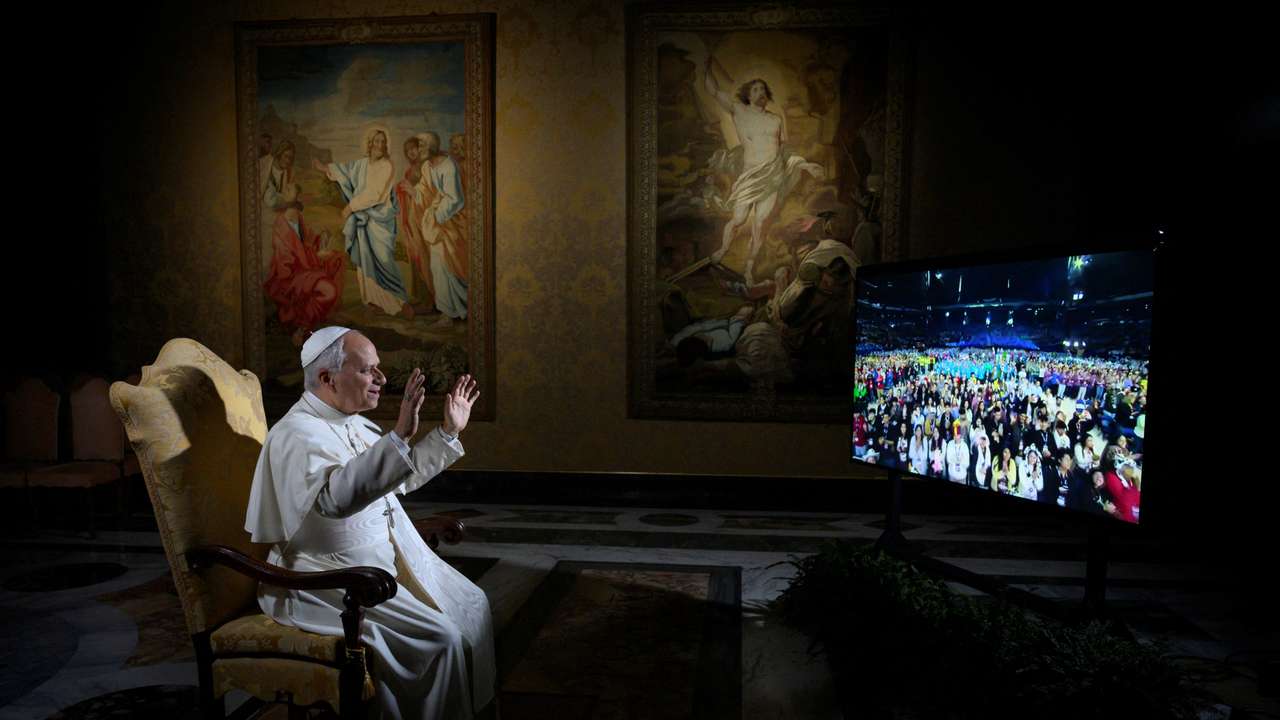 Pope Leo XIV gestures while speaking via video link with American youth during the National Conference of Catholic Youth