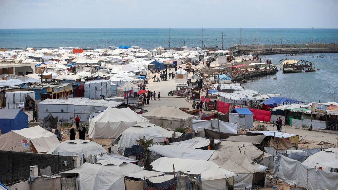 Palestinians displaced by the Israeli military offensive shelter in tents, in Gaza City