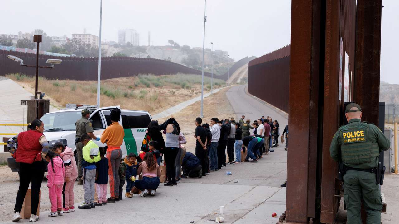 FILE PHOTO: Asylum-seekers at border walls between the U.S. and Mexico