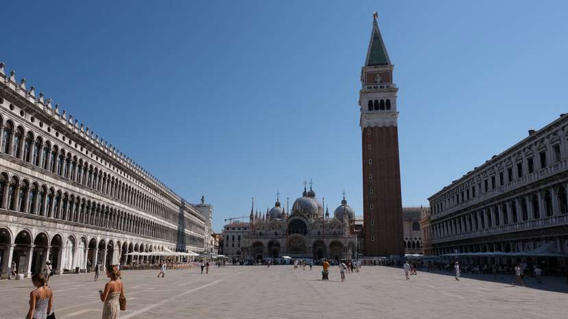 FILE PHOTO: Tourists walk during a new heatwave in Venice
