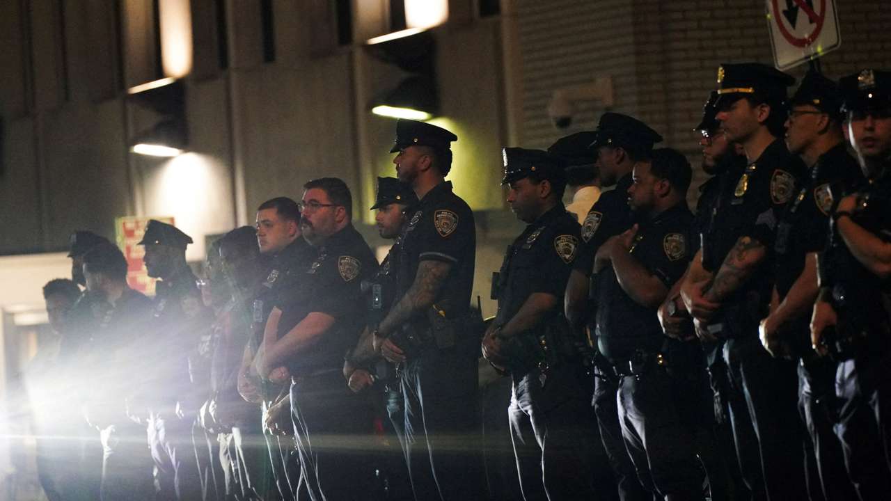 NYPD officers wait for the ambulance transfer of slain NYPD officer Didarul Islam, in New York City