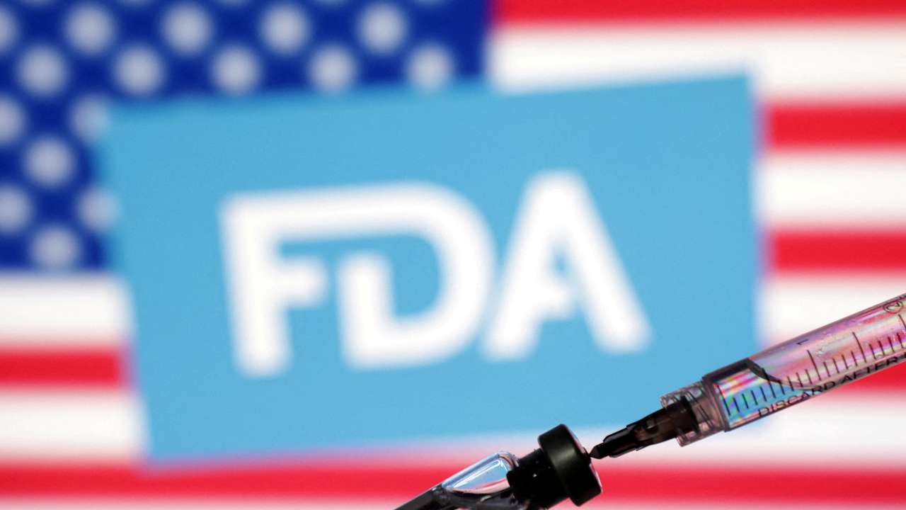 FILE PHOTO: Illustration shows U.S. flag, FDA logo, syringe and vial
