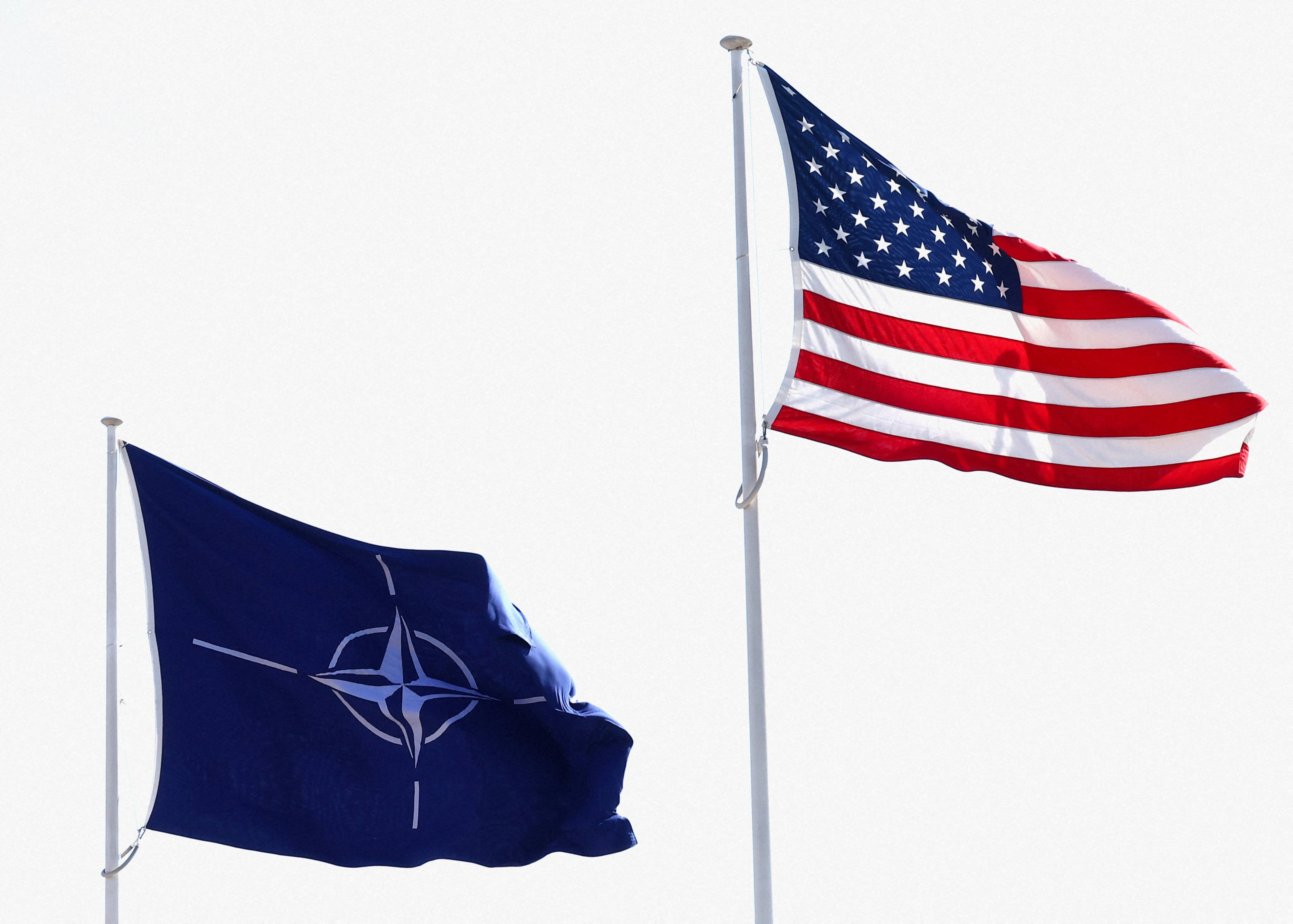 FILE PHOTO: The flags of NATO and the U.S. flutter at NATO headquarters in Brussels