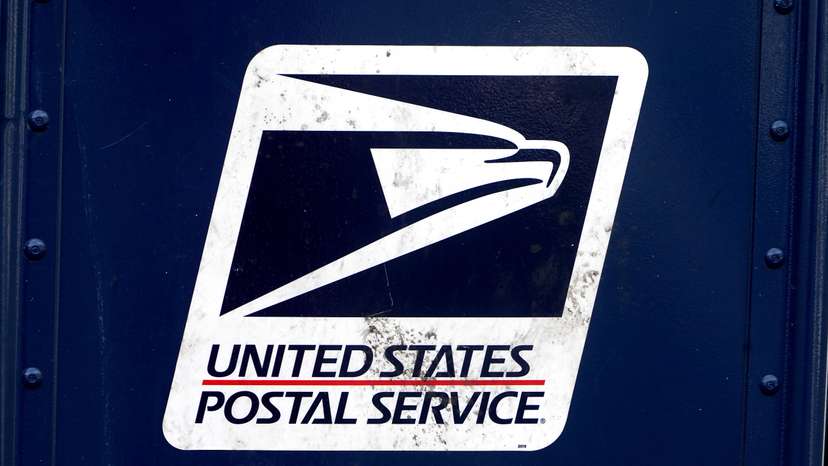 A U.S. Postal Service (USPS) logo is pictured on a mail box