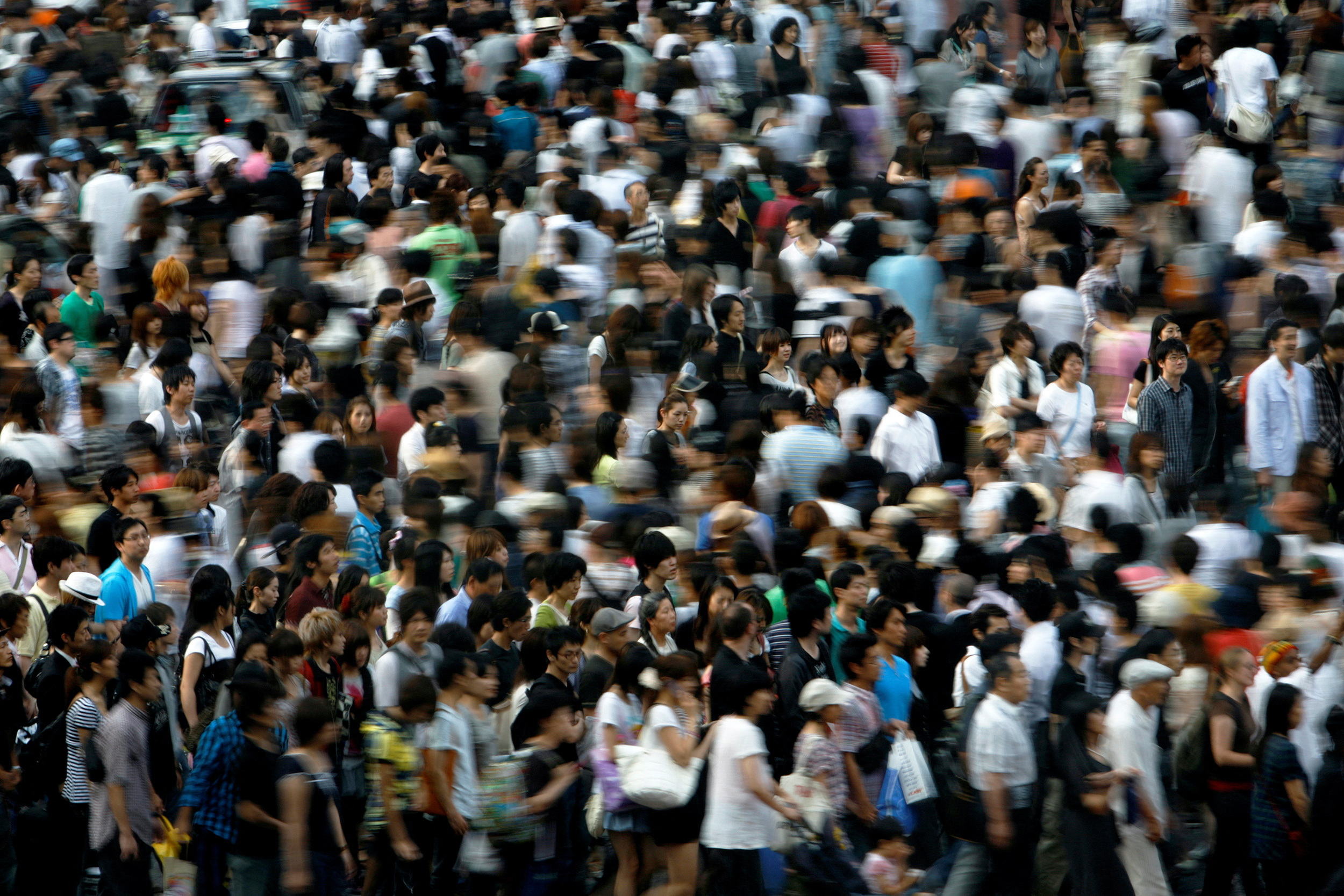 FILE PHOTO: People walk across a street in Tokyo