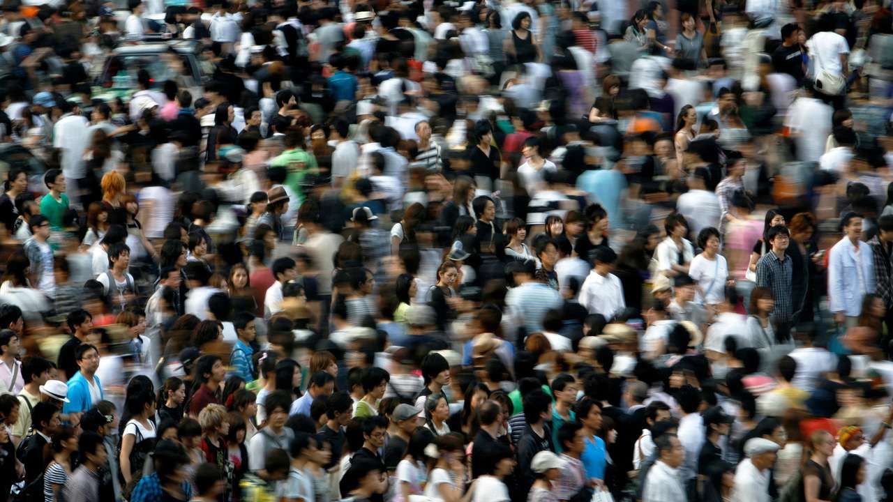 FILE PHOTO: People walk across a street in Tokyo