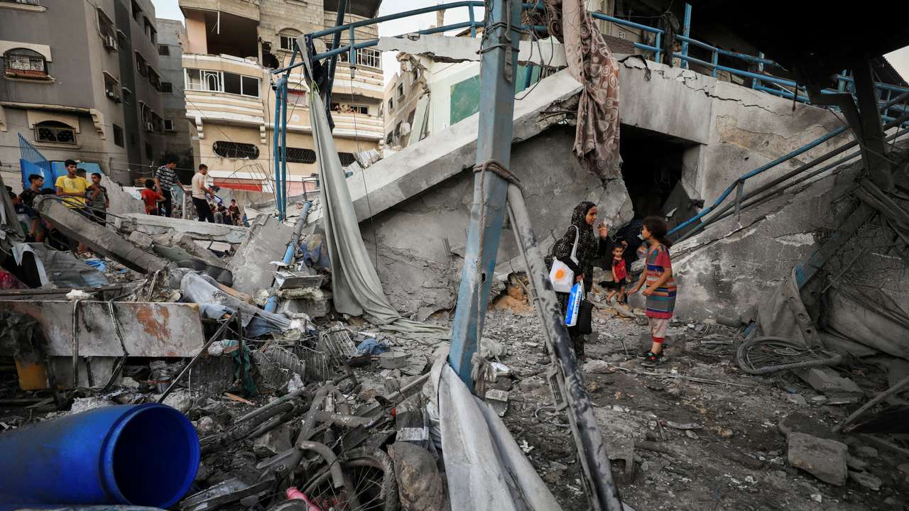 Palestinians gather at a UN school sheltering displaced people, following an Israeli strike, amid Israel-Hamas conflict, in Gaza City