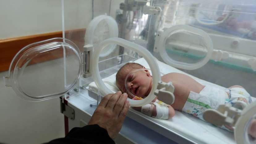 Palestinian baby Malek Yassin, who was saved from the womb of his mother Ola Al-Kurd, who was killed in an Israeli strike, according to medics, lies in an incubator at a hospital in central Gaza Strip