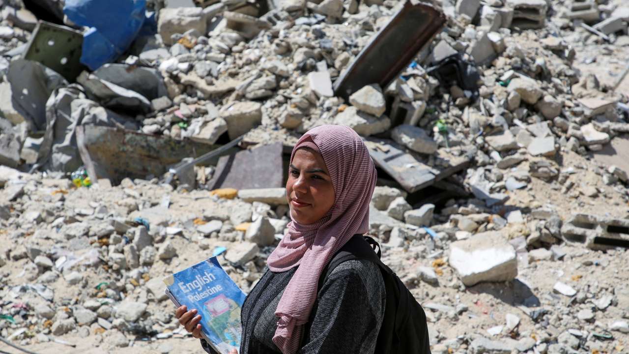 Gaza teacher welcomes students in a classroom tent set up on the rubble of her house