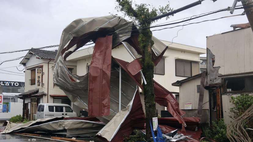 An object blown by strong winds caused by Typhoon Shanshan is stranded on a power line in Miyazaki, southwestern Japan