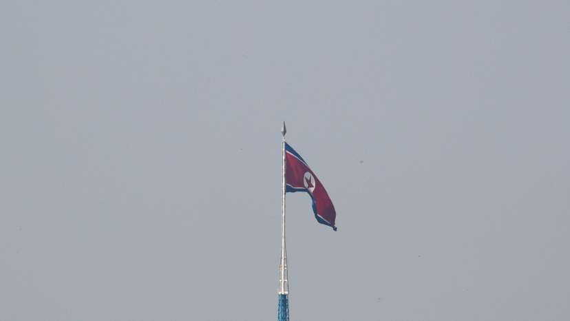 FILE PHOTO: A North Korean flag flutters on top of a tower at North Korea's propaganda village of Gijungdong, as seen from Paju