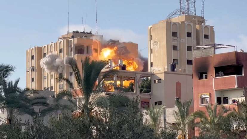 Smoke and flames rise following an Israeli strike on a residential building, amid the ongoing conflict between Israel and Hamas