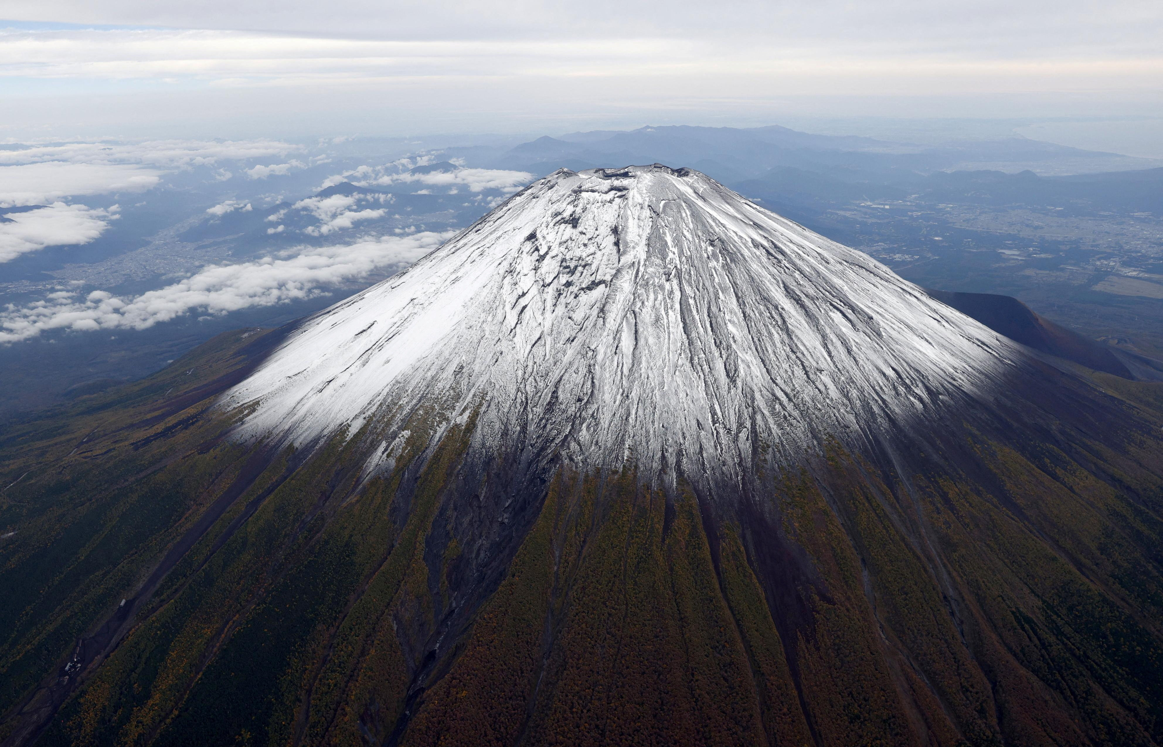 A photo taken from a helicopter shows the season's first snowcap on Mt. Fuji, Japan's highest mountain, located on the borders of Shizuoka and Yamanashi prefectures, in Japan