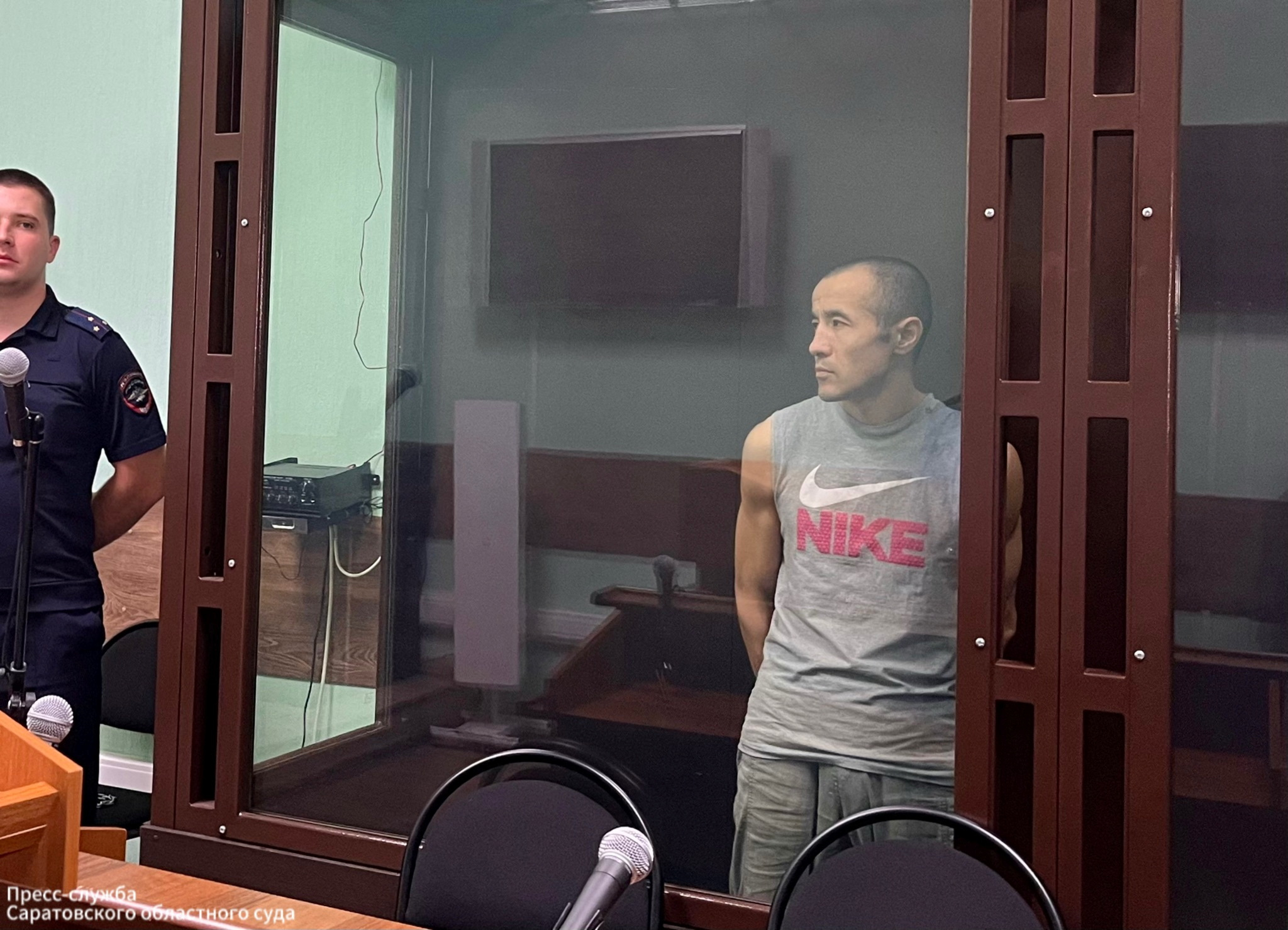 FILE PHOTO: Azamat Iskaliyev stands in a defendant cage during announcement of a 19 year jail verdict in Saratov