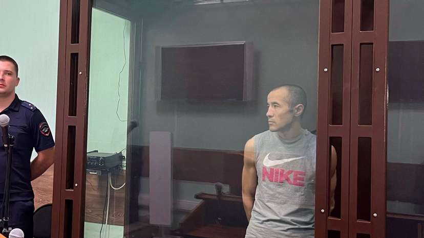 FILE PHOTO: Azamat Iskaliyev stands in a defendant cage during announcement of a 19 year jail verdict in Saratov