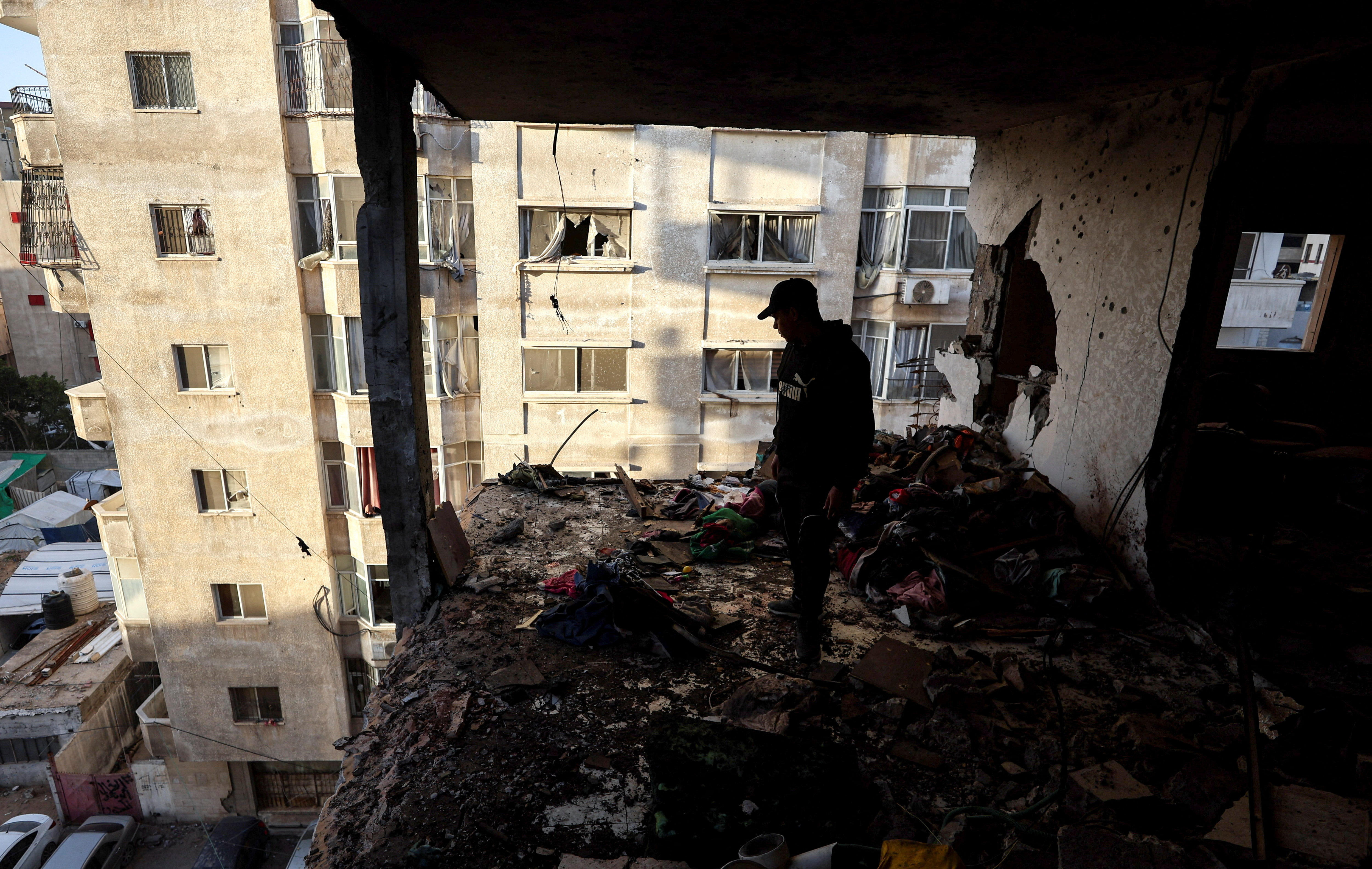 Palestinians inspect the site of an Israeli strike in Gaza City