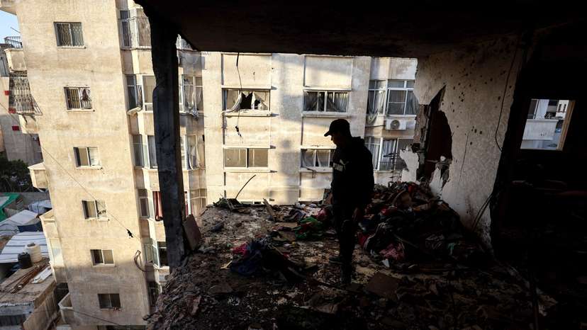 Palestinians inspect the site of an Israeli strike in Gaza City
