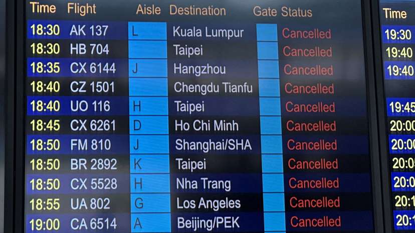 FILE PHOTO: A departure board displays flight cancellations at Hong Kong International Airport, as Super Typhoon Ragasa disrupts travel