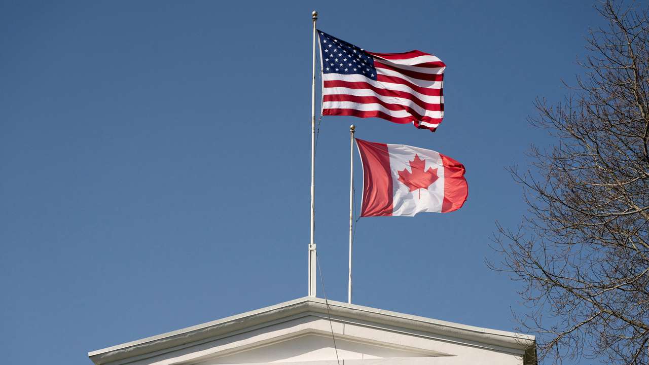 FILE PHOTO: Flags fly above the Peace Arch, on the day U.S. President Donald Trump announced new tariffs, at a Canada-U.S. border crossing known as the Peace Arch Border Crossing in Blaine