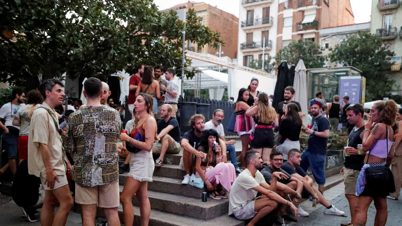 FILE PHOTO: Tourists and residents drink on a street in Gracia neighbourhood during a heatwave of the summer, in Barcelona