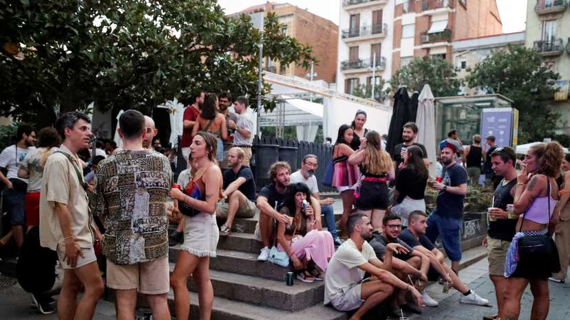 FILE PHOTO: Tourists and residents drink on a street in Gracia neighbourhood during a heatwave of the summer, in Barcelona