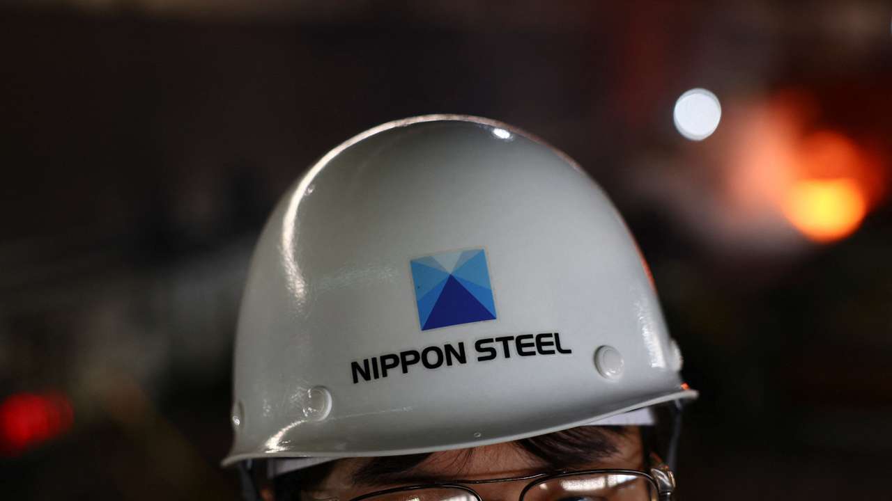 A worker wears a helmet with The Nippon Steel logo, inside the plate rolling mill area at the company's East Nippon Works Kimitsu Area plant in Kimitsu