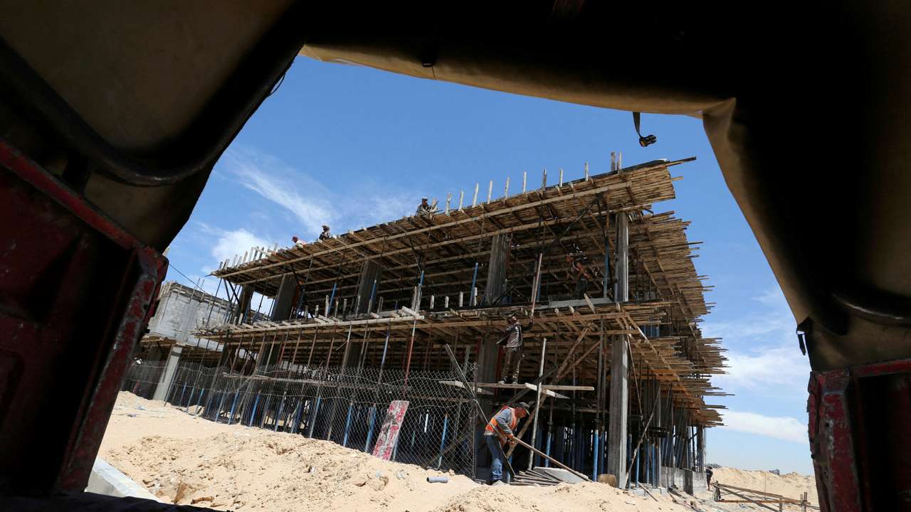 FILE PHOTO: Palestinian workers work on a Qatari-funded construction project in the southern Gaza Strip