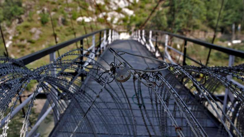 FILE PHOTO: A view shows a padlock on concertina wires on a footbridge connecting Indian administered Kashmir and Pakistan administered Kashmir in Teetwal