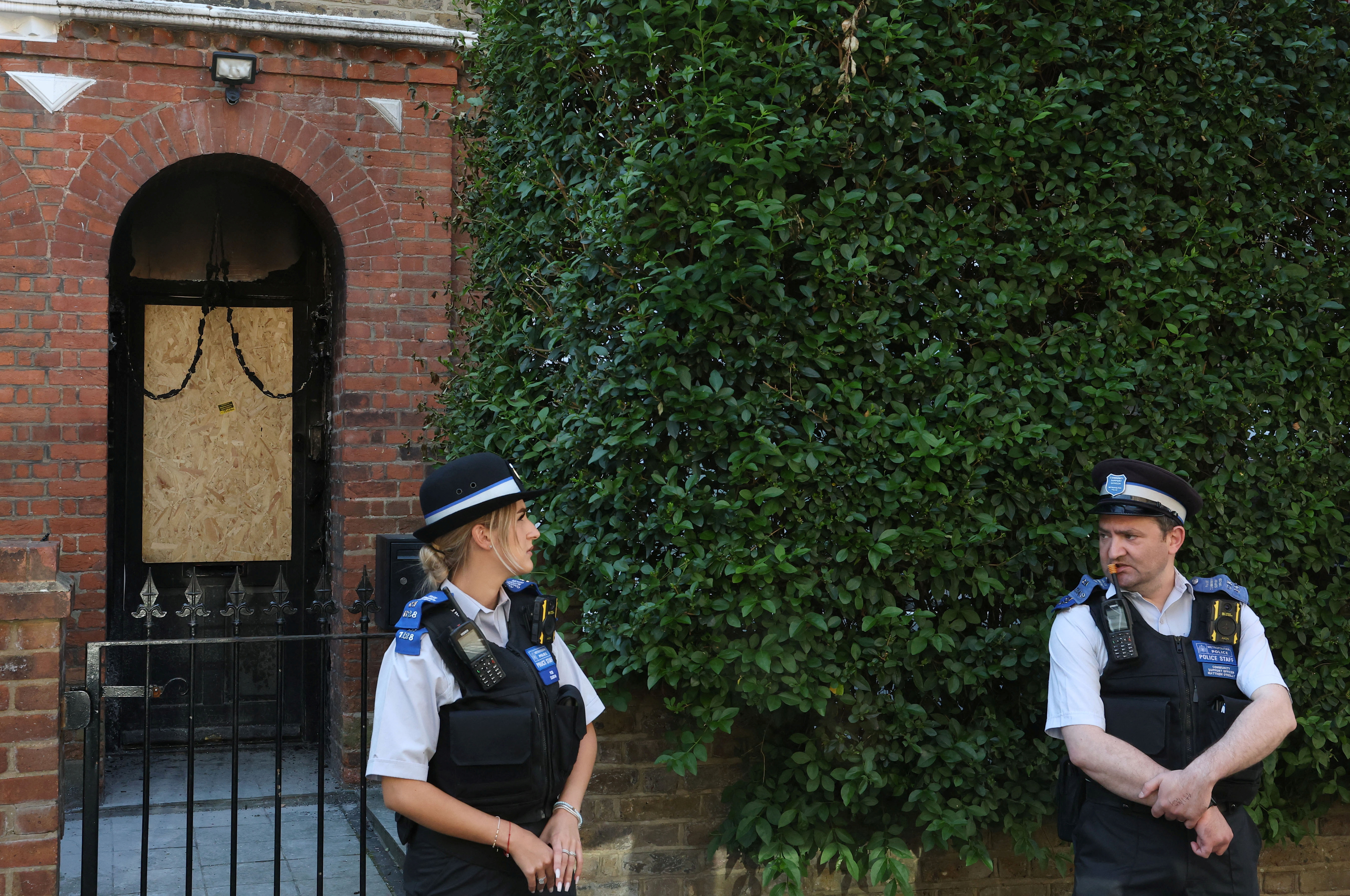 Police officers stand outside Britain's Prime Minister Starmer's home, after it was damaged by fire in suspected arson attack in north London