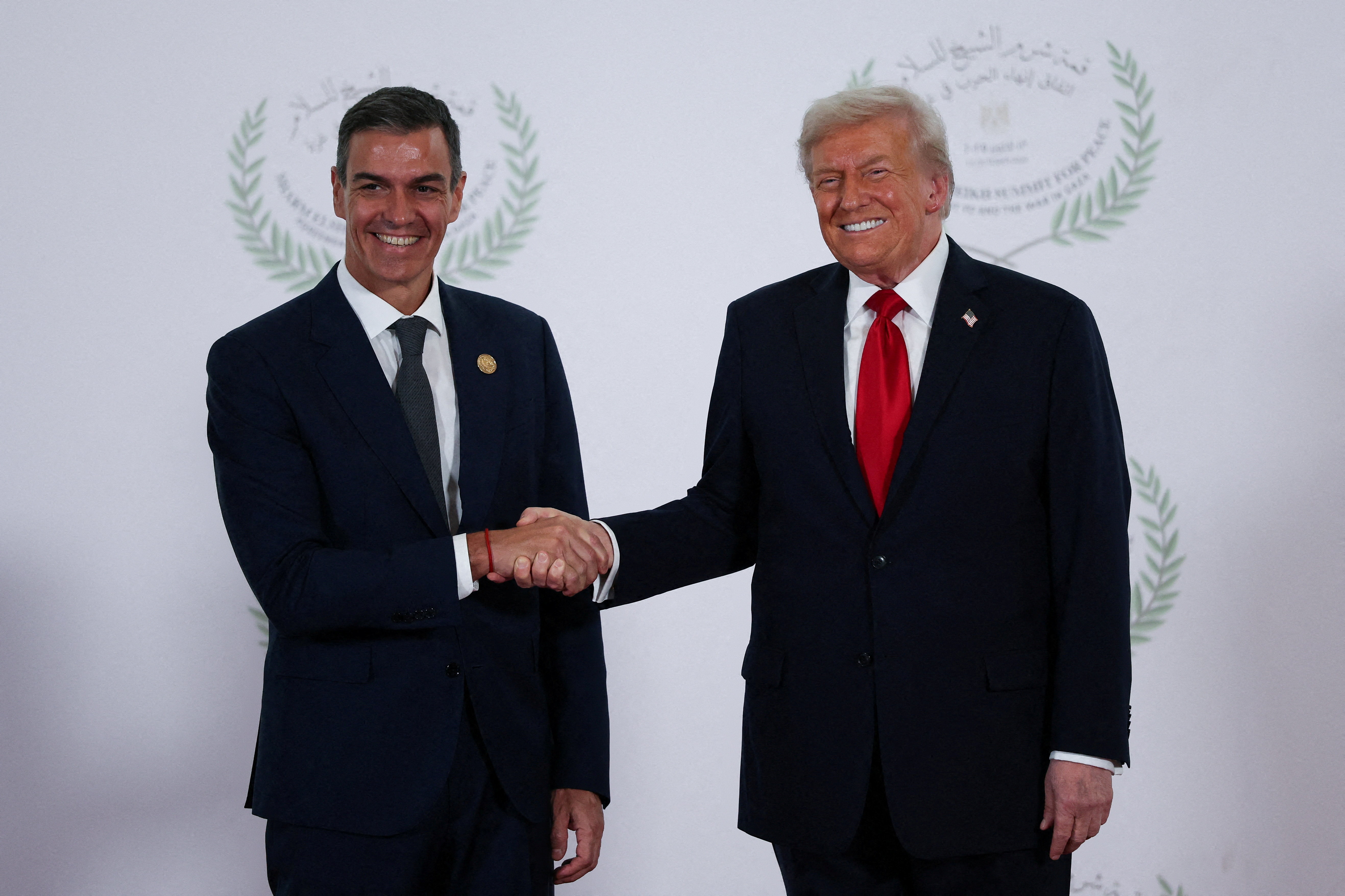 FILE PHOTO: U.S. President Donald Trump and Spanish Prime Minister Pedro Sanchez shake hands as they pose for a photo