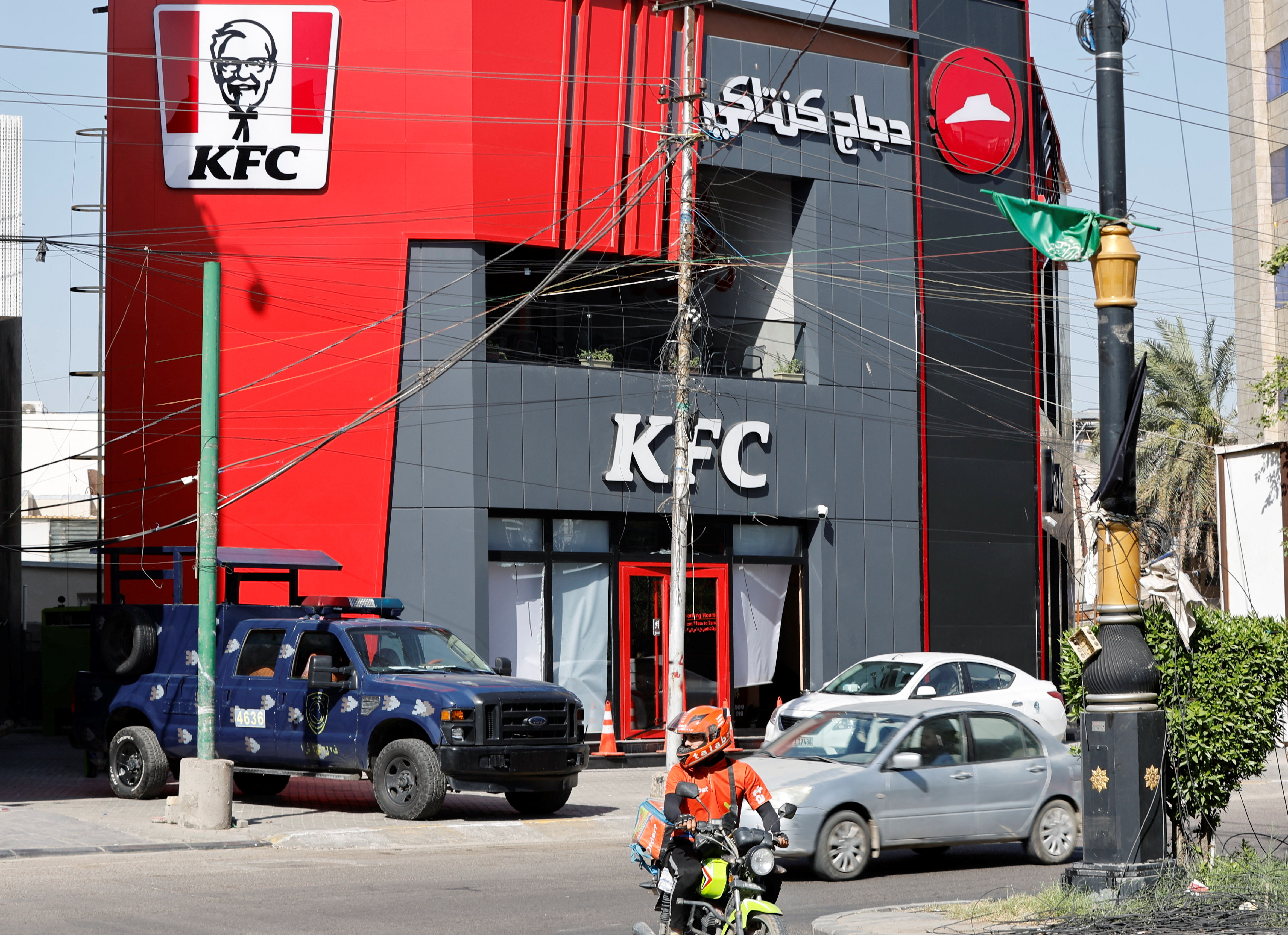 A Federal police vehicle is parked near a KFC fast food restaurant following an attack in Baghdad
