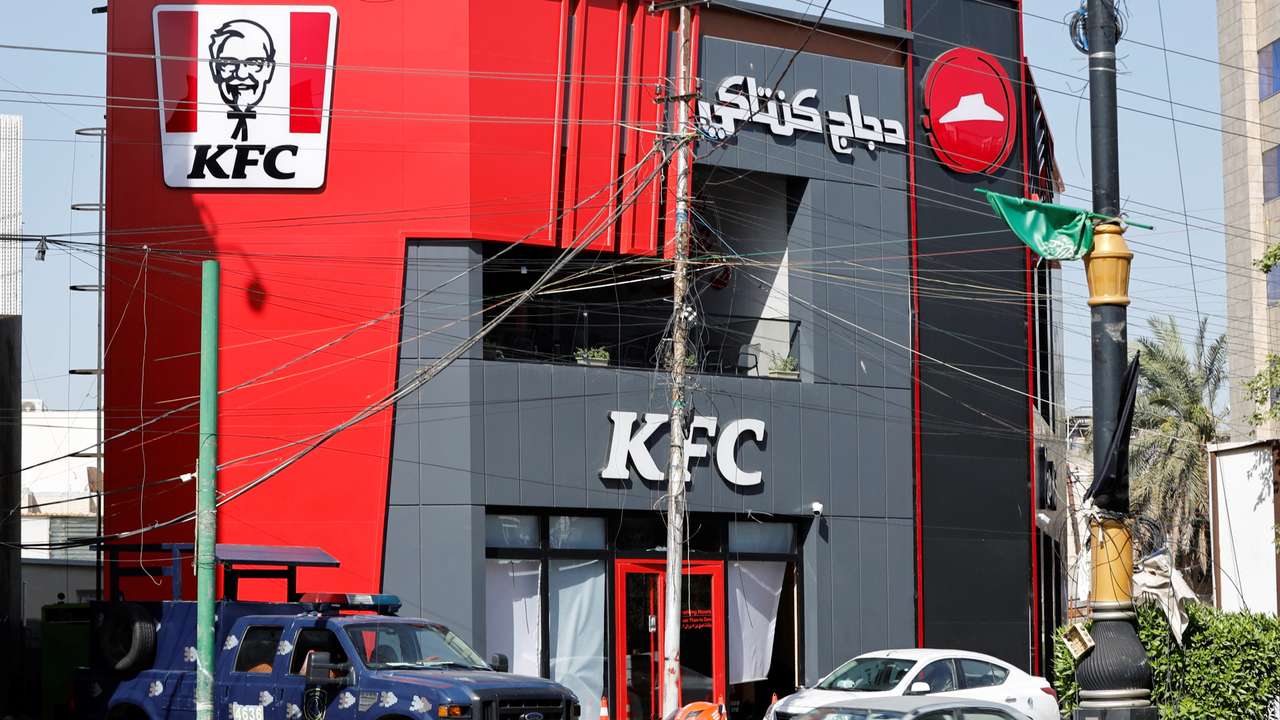 A Federal police vehicle is parked near a KFC fast food restaurant following an attack in Baghdad
