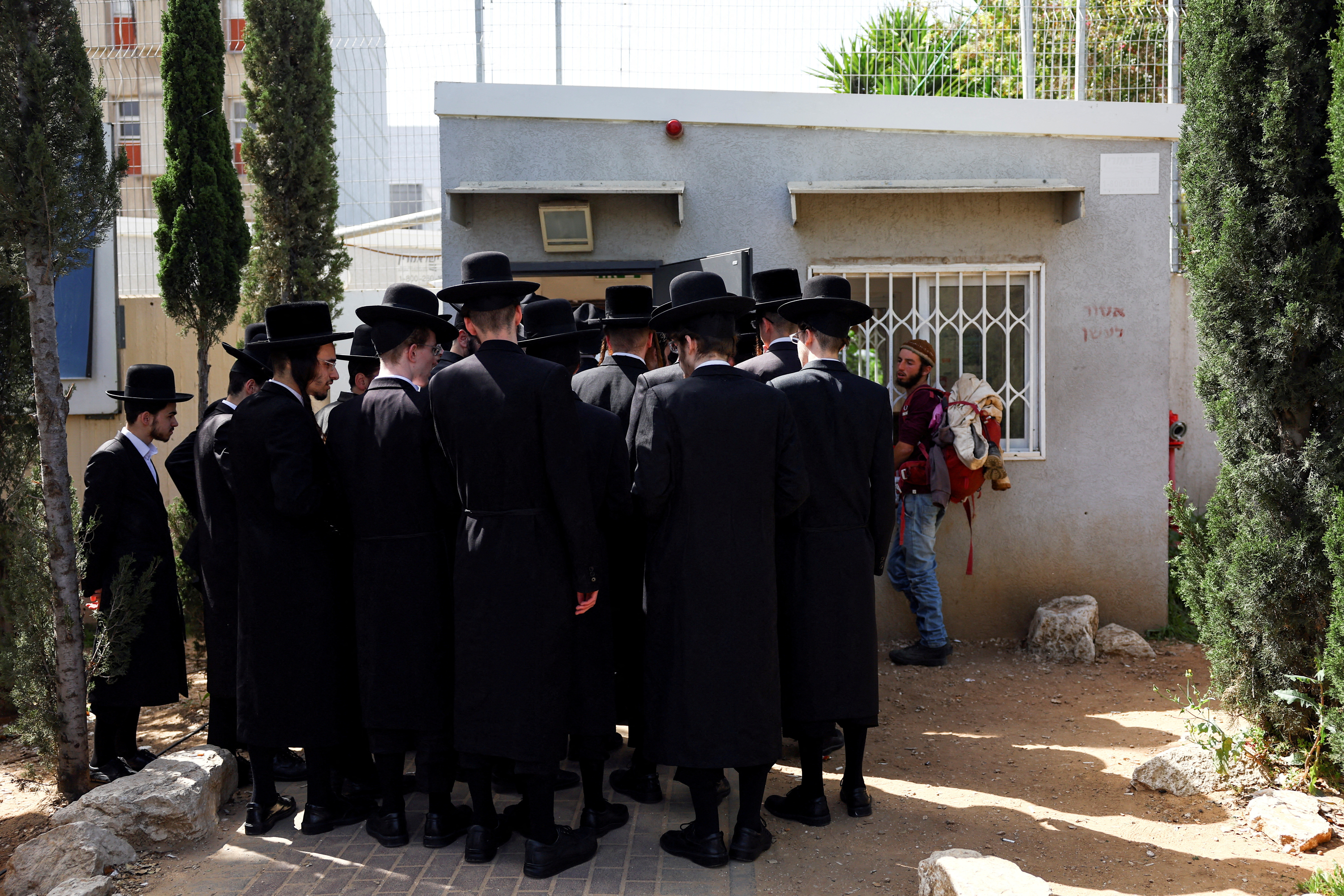 FILE PHOTO: Ultra-Orthodox Jews line up at an Israeli draft office to process their exemptions from mandatory military service at a recruitment base in Kiryat Ono