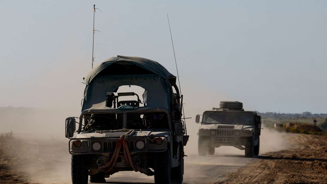 Israeli military vehicles manoeuvre near the Israel-Gaza border
