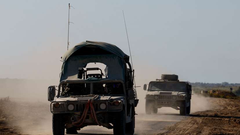 Israeli military vehicles manoeuvre near the Israel-Gaza border
