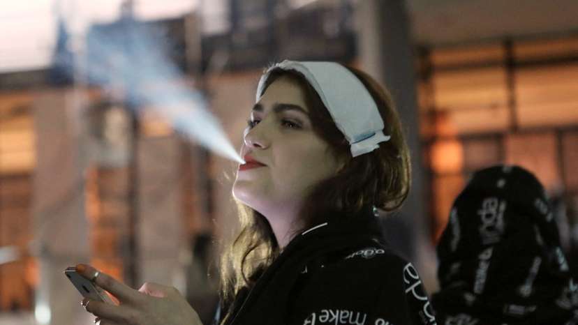 FILE PHOTO: A model smokes a cigarette during Sao Paulo Fashion Week