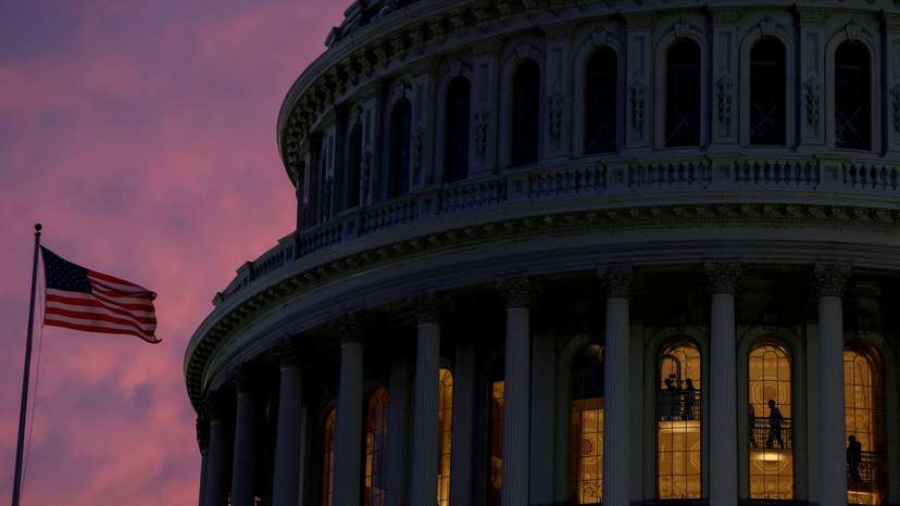 FILE PHOTO: People walk inside the upper floors of the rotunda of the U.S. Capitol building at sunset in Washington