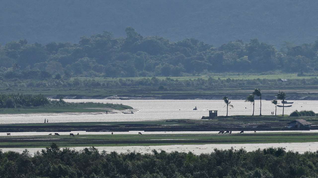 FILE PHOTO: People of Maungdaw township of Myanmar are seen from the Teknaf area of Bangladesh, at the Myanmar-Bangladesh border