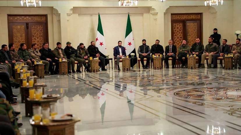 Syria's de facto leader Ahmed al-Sharaa attends a meeting with former rebel faction chiefs, in Damascus