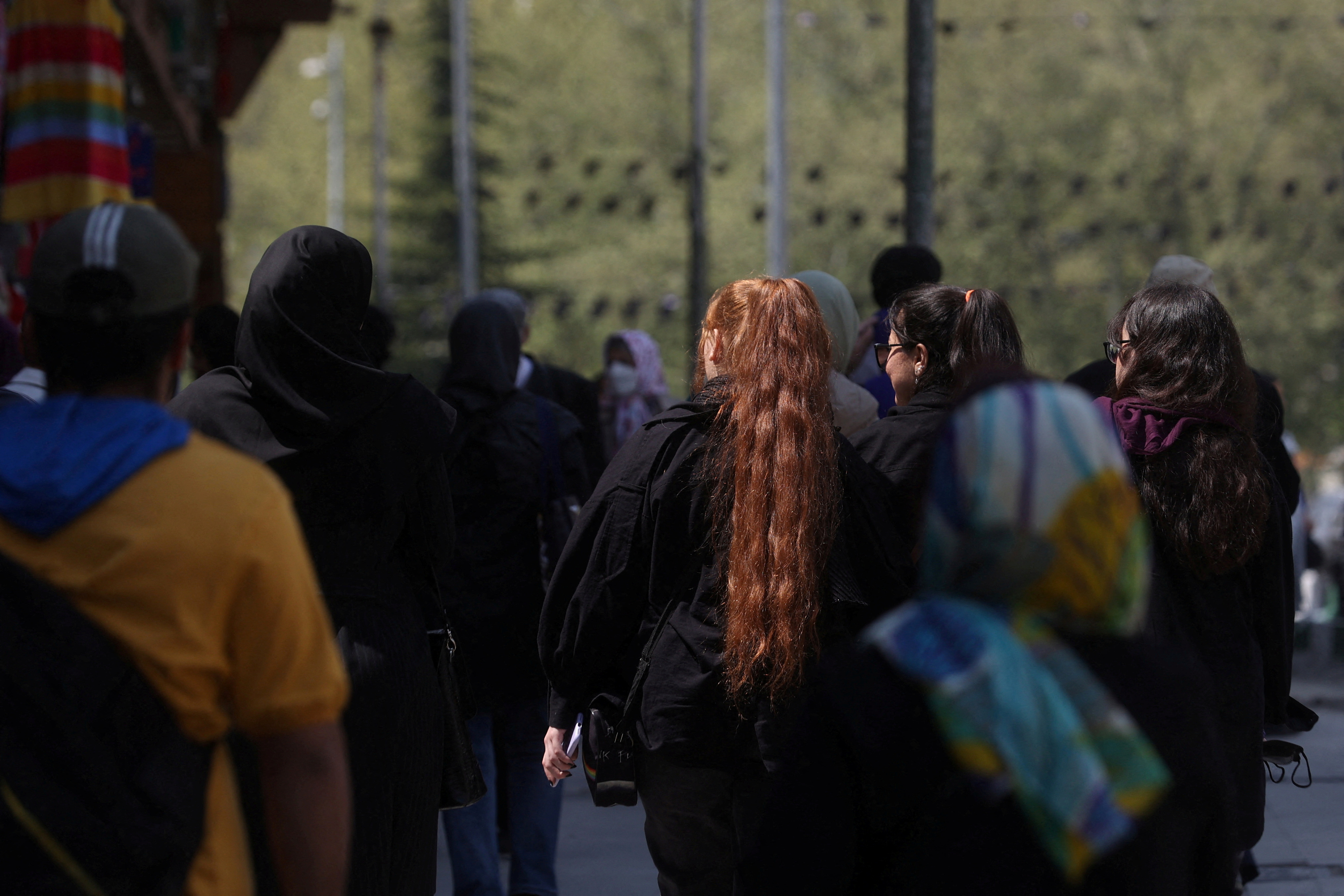 FILE PHOTO: People walk on a street amid the implementation of the new hijab surveillance in Tehran