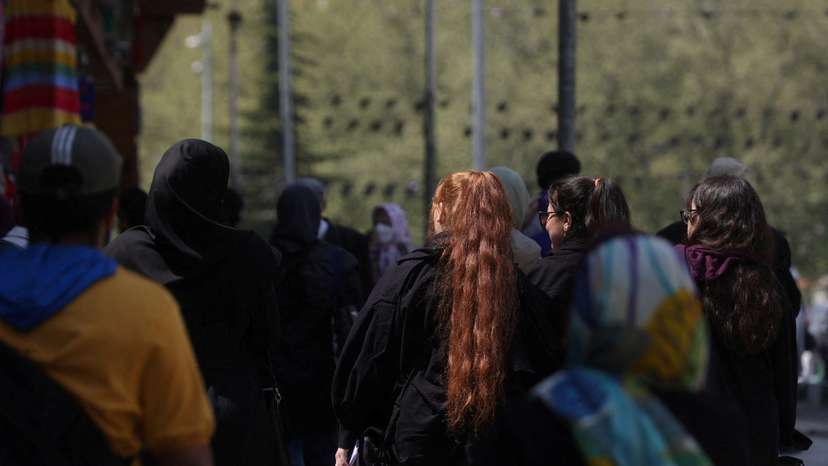 FILE PHOTO: People walk on a street amid the implementation of the new hijab surveillance in Tehran